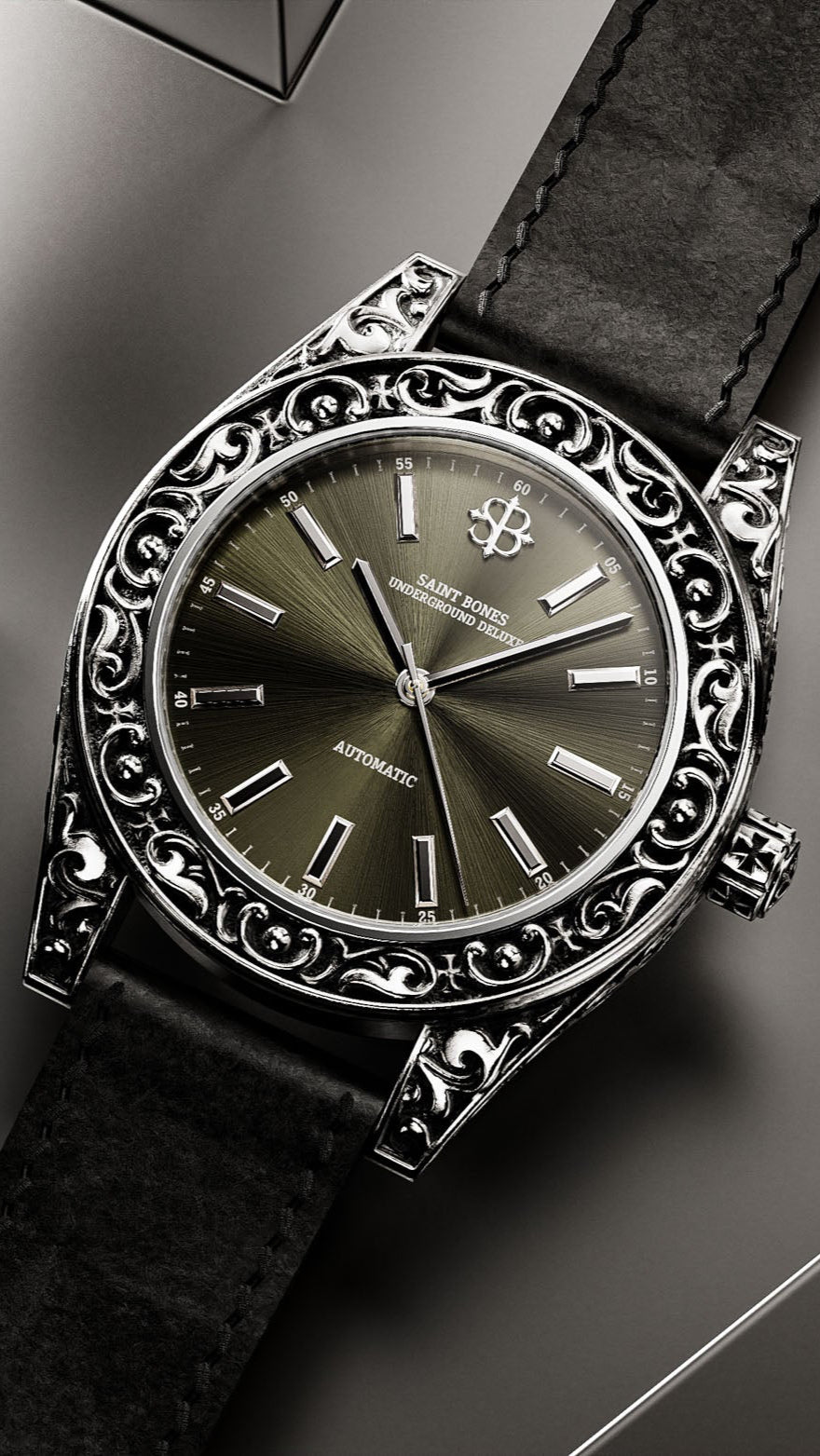 Decorative wristwatch with black strap on a gray surface