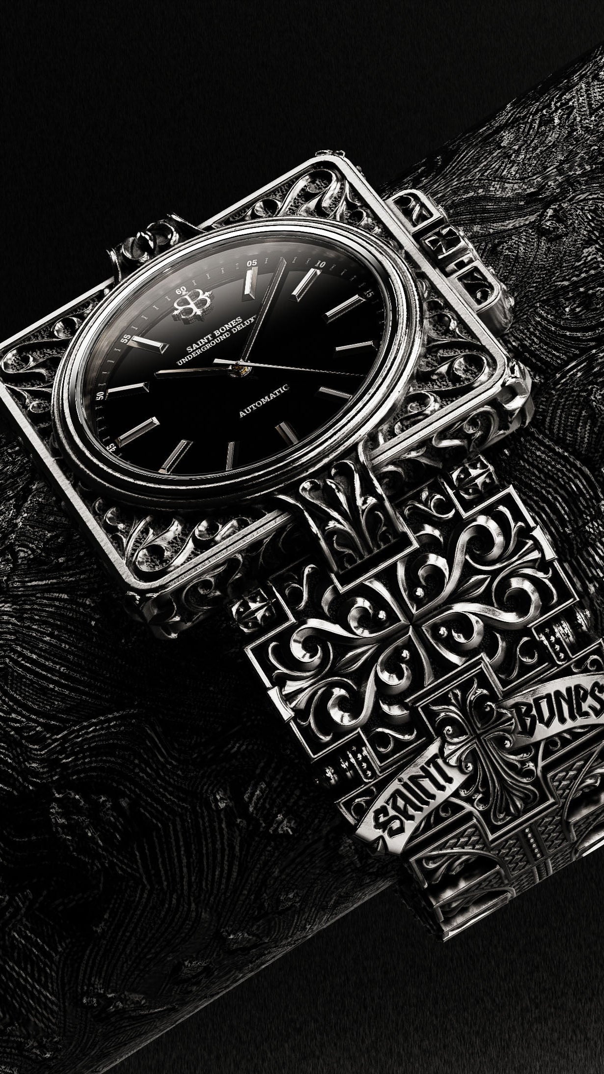 Silver watch with intricate design on a textured surface